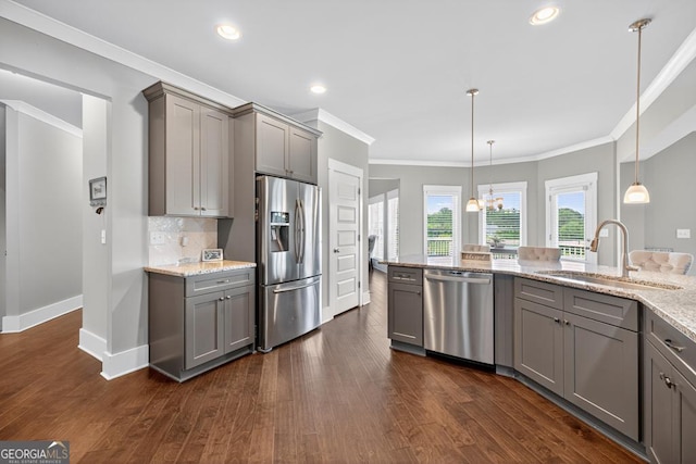2112 Meadowood Cv, Monroe, GA 30655 - kitchen featuring stainless steel appliances, gray cabinetry, ornamental molding, light stone counters, and dark wood-type flooring