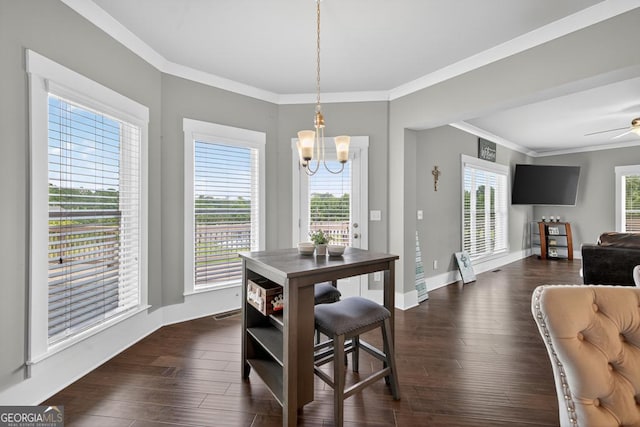 2112 Meadowood Cv, Monroe, GA 30655 - dining space featuring a chandelier, crown molding, dark wood-type flooring, and a ceiling fan