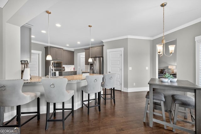 2112 Meadowood Cv, Monroe, GA 30655 - kitchen with appliances with stainless steel finishes, ornamental molding, recessed lighting, dark wood-style floors, and a peninsula