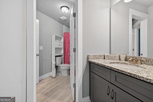2112 Meadowood Cv, Monroe, GA 30655 - full bath with vanity, a shower with shower curtain, and wood finished floors