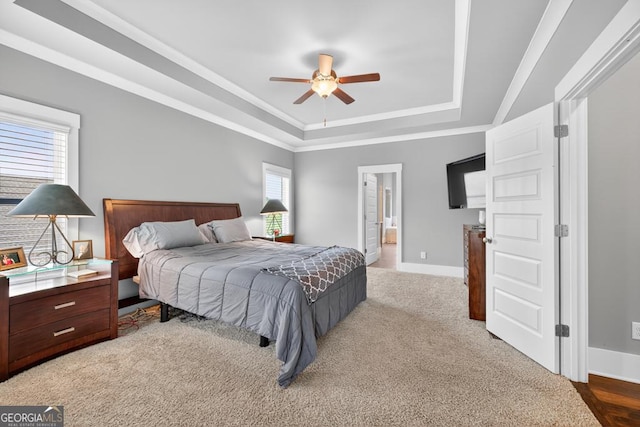2112 Meadowood Cv, Monroe, GA 30655 - carpeted bedroom with a tray ceiling, connected bathroom, and a ceiling fan