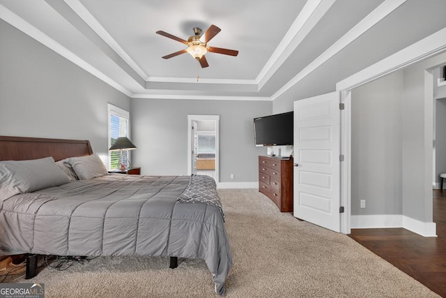 2112 Meadowood Cv, Monroe, GA 30655 - bedroom featuring a raised ceiling, ornamental molding, ceiling fan, and ensuite bath