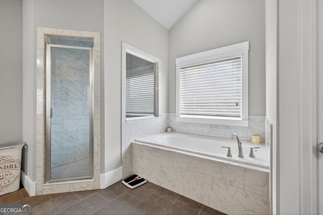 2112 Meadowood Cv, Monroe, GA 30655 - full bathroom with a shower stall, a bath, lofted ceiling, and tile patterned flooring