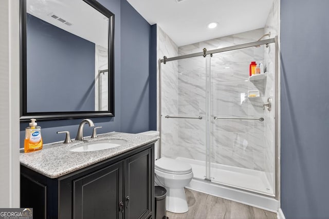 2112 Meadowood Cv, Monroe, GA 30655 - full bath with a marble finish shower, vanity, and wood finished floors
