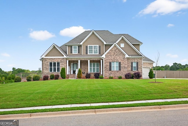 2112 Meadowood Cv, Monroe, GA 30655 - craftsman-style house featuring a porch, brick siding, and an attached garage