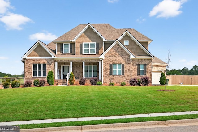 2112 Meadowood Cv, Monroe, GA 30655 - craftsman house with brick siding, covered porch, and a garage