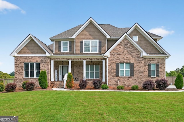 2112 Meadowood Cv, Monroe, GA 30655 - craftsman house with brick siding, a front yard, and covered porch