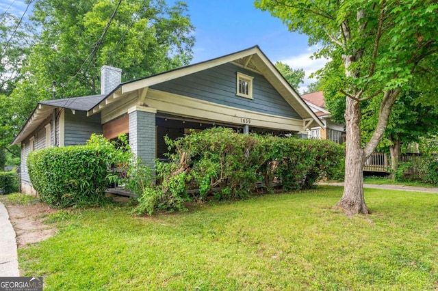 1639 Rogers Ave SW, Atlanta, GA 30310 - view of property exterior with a chimney, a yard, and brick siding