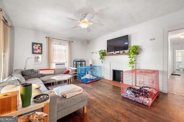 1639 Rogers Ave SW, Atlanta, GA 30310 - living room with ceiling fan, wood finished floors, a fireplace, ornamental molding, and cooling unit