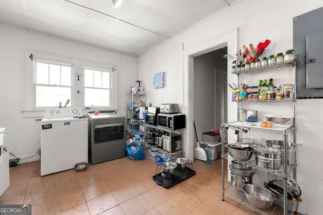 1639 Rogers Ave SW, Atlanta, GA 30310 - kitchen with independent washer and dryer, stainless steel microwave, electric panel, and light tile patterned floors