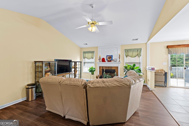 10 Links Ct, Newnan, GA 30265 - living room featuring vaulted ceiling, ceiling fan, healthy amount of natural light, dark wood-style flooring, and a brick fireplace