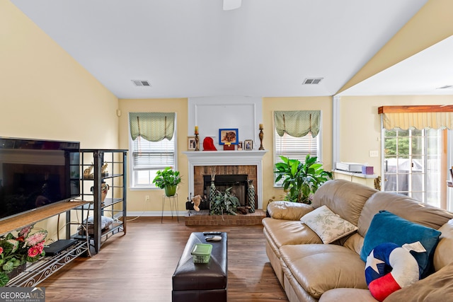 10 Links Ct, Newnan, GA 30265 - living area featuring a fireplace, wood finished floors, healthy amount of natural light, and vaulted ceiling