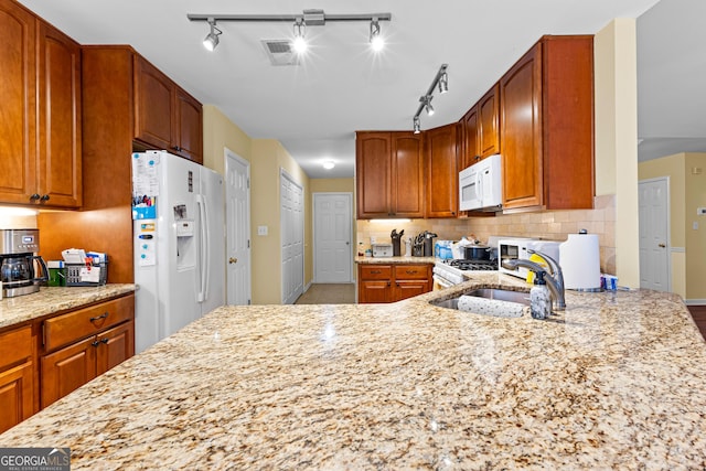 10 Links Ct, Newnan, GA 30265 - kitchen with white appliances, light stone countertops, tasteful backsplash, and brown cabinets