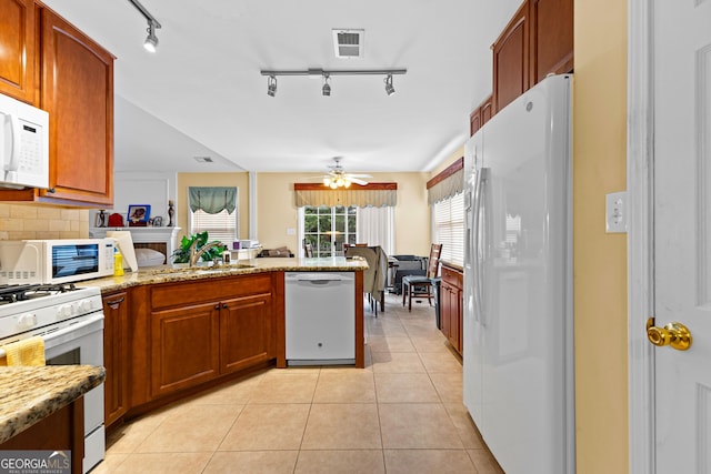 10 Links Ct, Newnan, GA 30265 - kitchen with white appliances, a peninsula, a ceiling fan, light tile patterned flooring, and tasteful backsplash