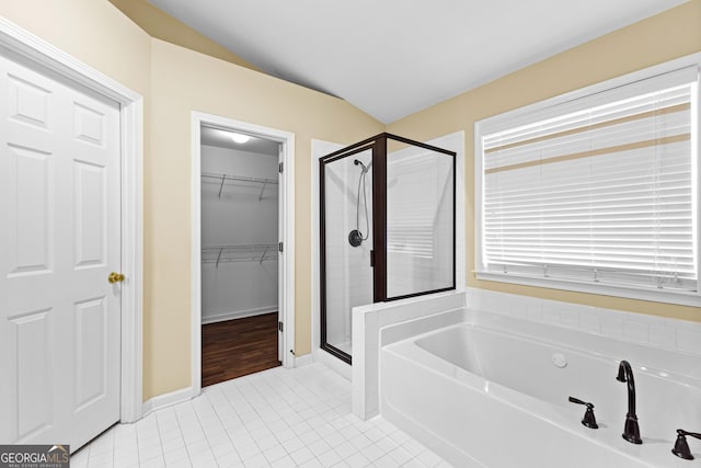 10 Links Ct, Newnan, GA 30265 - full bath with a stall shower, a garden tub, a walk in closet, tile patterned floors, and vaulted ceiling