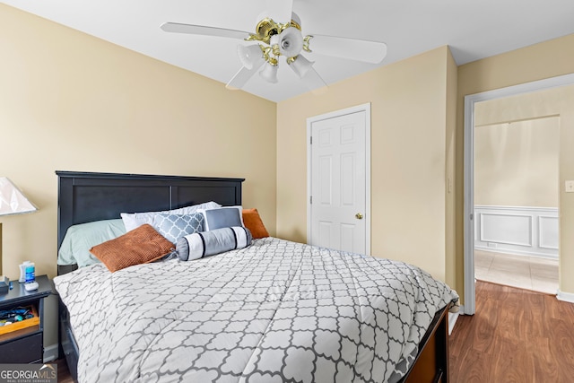 10 Links Ct, Newnan, GA 30265 - bedroom featuring wood finished floors, a ceiling fan, and wainscoting