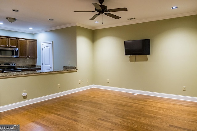 105 Maplecrest Ln SE, Rome, GA 30161 - kitchen featuring range with electric stovetop, stainless steel microwave, light wood-type flooring, recessed lighting, and dark brown cabinets
