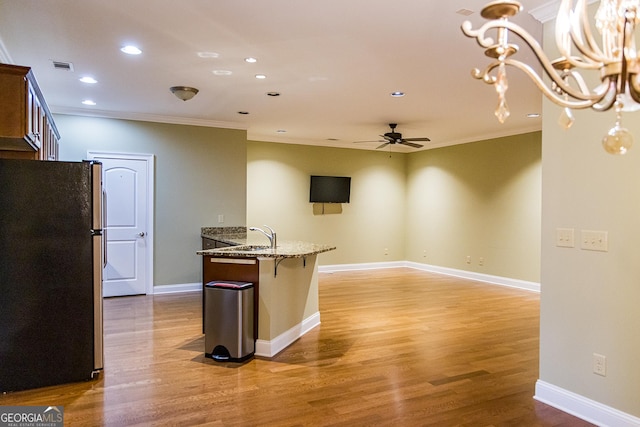 105 Maplecrest Ln SE, Rome, GA 30161 - kitchen featuring freestanding refrigerator, a ceiling fan, ornamental molding, light stone countertops, and light wood finished floors