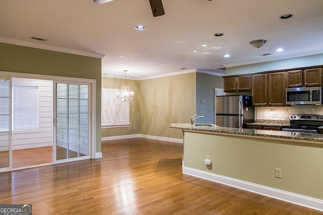 105 Maplecrest Ln SE, Rome, GA 30161 - kitchen featuring appliances with stainless steel finishes, crown molding, decorative backsplash, ceiling fan, and dark brown cabinetry