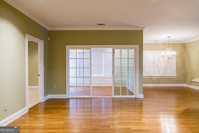 105 Maplecrest Ln SE, Rome, GA 30161 - spare room with light wood-type flooring, a chandelier, and ornamental molding
