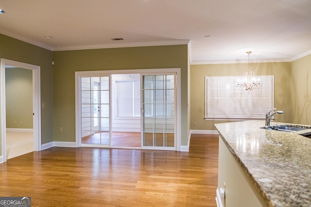 105 Maplecrest Ln SE, Rome, GA 30161 - unfurnished dining area featuring light wood finished floors, a chandelier, and ornamental molding