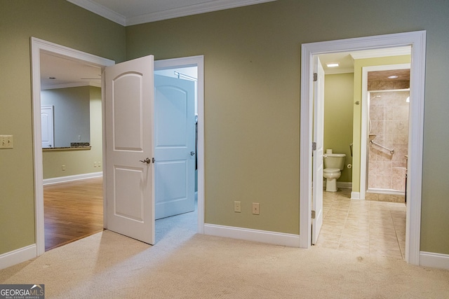 105 Maplecrest Ln SE, Rome, GA 30161 - unfurnished bedroom with crown molding, carpet, connected bathroom, and a walk in closet