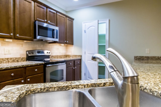 105 Maplecrest Ln SE, Rome, GA 30161 - kitchen with stainless steel appliances, tasteful backsplash, and light stone counters