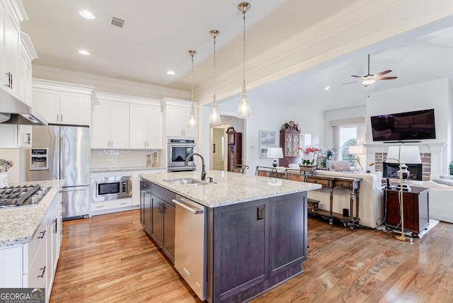 1911 Bent Pine Park, Statham, GA 30666 - kitchen with stainless steel appliances, white cabinets, open floor plan, light wood-style floors, and ornamental molding