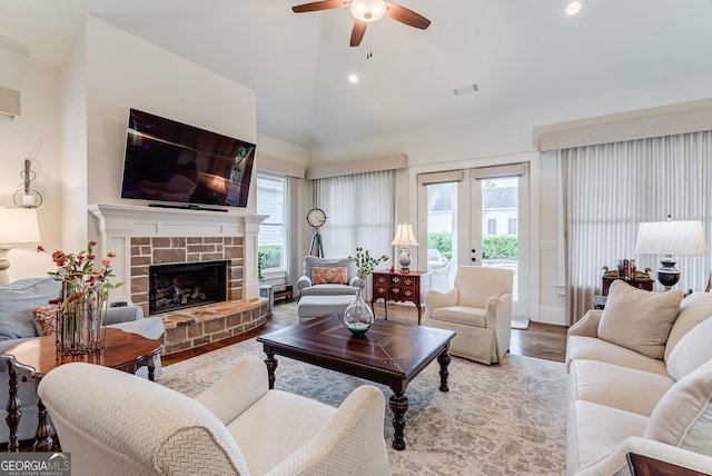 1911 Bent Pine Park, Statham, GA 30666 - living room featuring healthy amount of natural light, a ceiling fan, vaulted ceiling, wood finished floors, and a stone fireplace