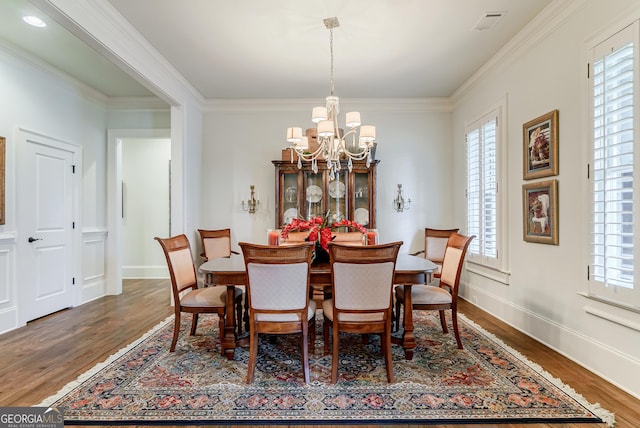 1911 Bent Pine Park, Statham, GA 30666 - dining space with a chandelier, wood finished floors, healthy amount of natural light, and crown molding