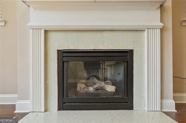 2638 Lake Manor Cir, Duluth, GA 30096 - detailed view of a glass covered fireplace, wood finished floors, and ornamental molding