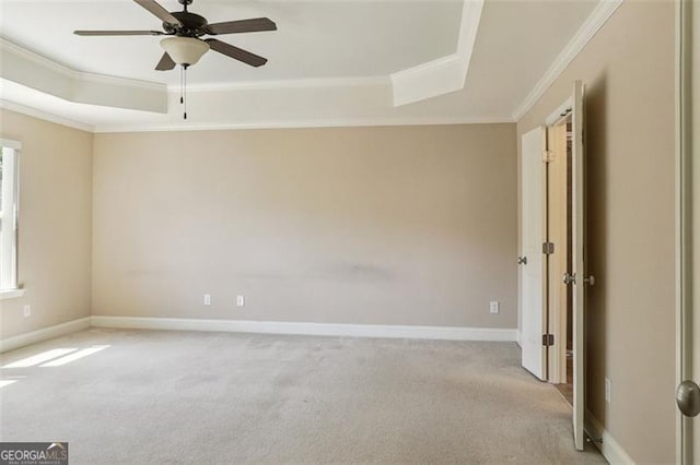 2638 Lake Manor Cir, Duluth, GA 30096 - empty room featuring a tray ceiling, ornamental molding, light colored carpet, and ceiling fan