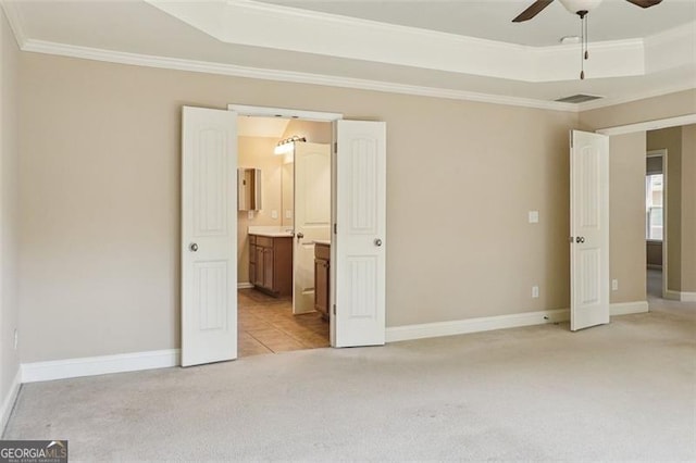 2638 Lake Manor Cir, Duluth, GA 30096 - unfurnished bedroom featuring light carpet, crown molding, a tray ceiling, connected bathroom, and ceiling fan