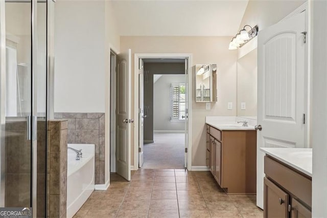 2638 Lake Manor Cir, Duluth, GA 30096 - full bath featuring vanity, a garden tub, a stall shower, and tile patterned floors