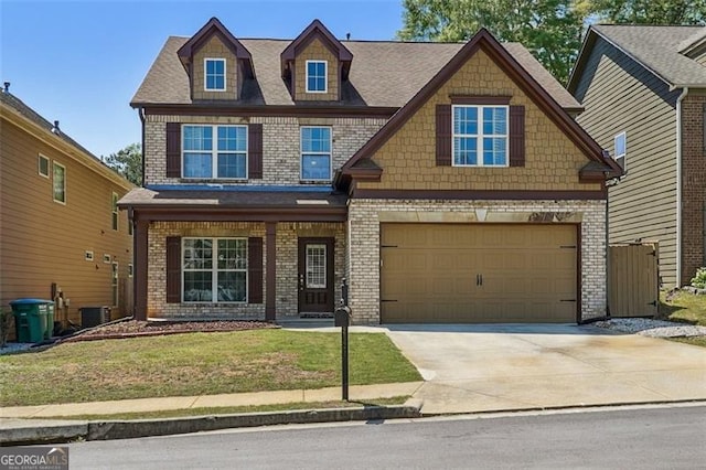 2638 Lake Manor Cir, Duluth, GA 30096 - craftsman inspired home with a garage, driveway, brick siding, and a front lawn
