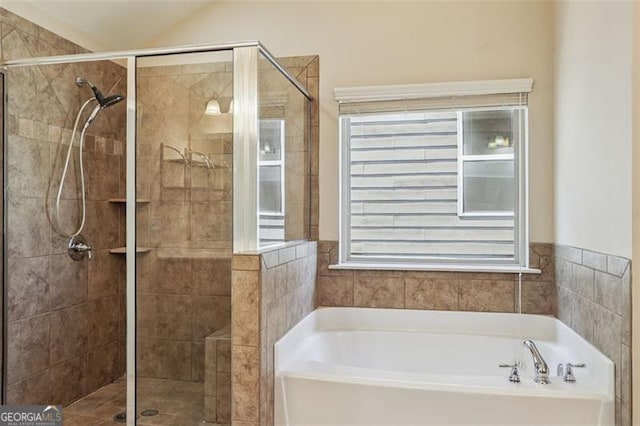 2638 Lake Manor Cir, Duluth, GA 30096 - bathroom with a bath, a shower stall, and lofted ceiling