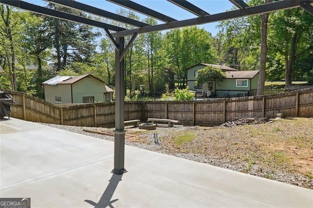 2638 Lake Manor Cir, Duluth, GA 30096 - view of patio featuring an outdoor fire pit, a pergola, and view of scattered trees