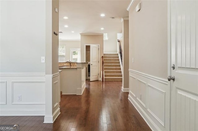 2638 Lake Manor Cir, Duluth, GA 30096 - hallway with a decorative wall, wainscoting, dark wood-type flooring, stairway, and ornamental molding
