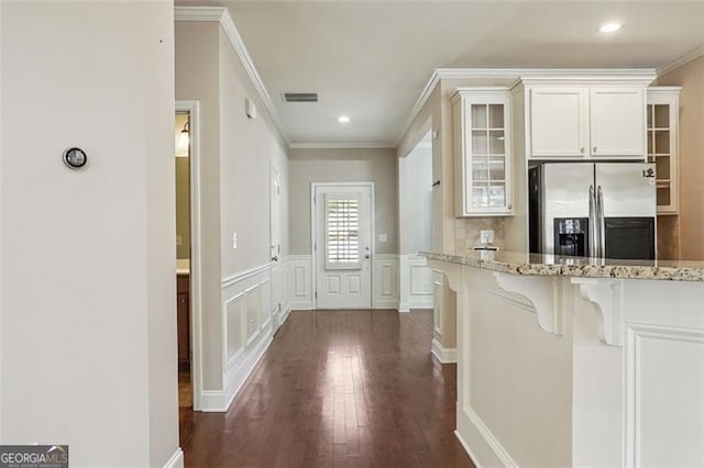 2638 Lake Manor Cir, Duluth, GA 30096 - kitchen with stainless steel fridge with ice dispenser, glass insert cabinets, a kitchen breakfast bar, light stone countertops, and dark wood-style flooring