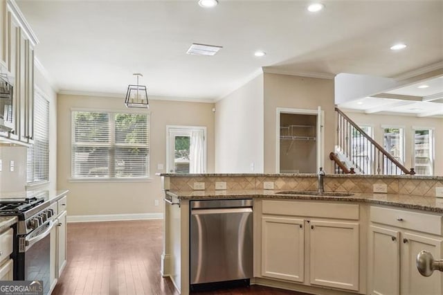 2638 Lake Manor Cir, Duluth, GA 30096 - kitchen featuring stainless steel appliances, recessed lighting, decorative backsplash, plenty of natural light, and ornamental molding