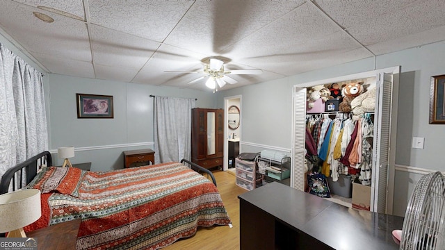15 Aragon Rd, Aragon, GA 30104 - bedroom with light wood-type flooring, a drop ceiling, ceiling fan, a spacious closet, and a closet