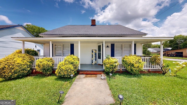 15 Aragon Rd, Aragon, GA 30104 - view of front of house with covered porch, a chimney, and a front lawn