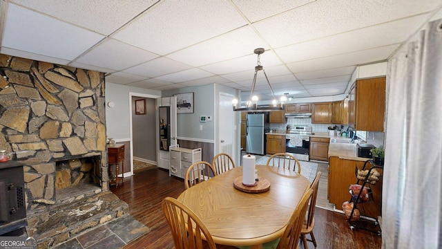 15 Aragon Rd, Aragon, GA 30104 - dining space featuring dark wood-style flooring, a drop ceiling, and wainscoting