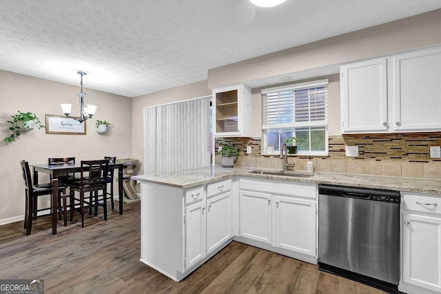 1066 Wedgewood Ln, Tucker, GA 30084 - kitchen with dishwasher, a peninsula, a chandelier, white cabinetry, and a textured ceiling