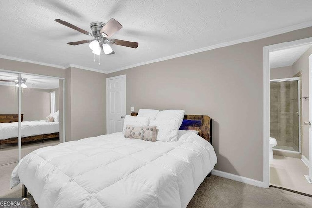 1066 Wedgewood Ln, Tucker, GA 30084 - carpeted bedroom featuring ceiling fan, crown molding, ensuite bathroom, a textured ceiling, and a closet