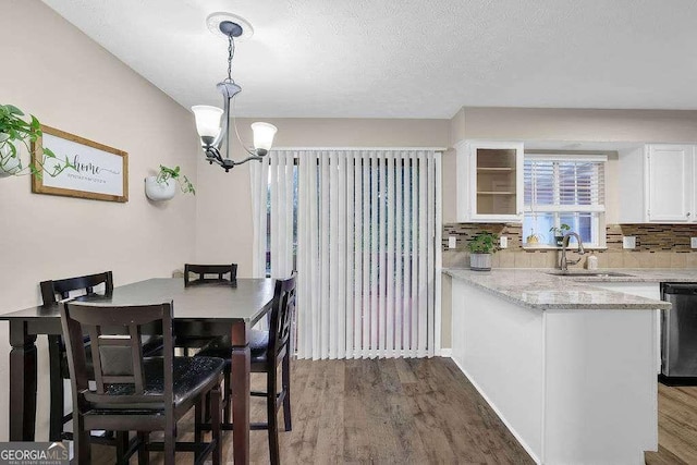 1066 Wedgewood Ln, Tucker, GA 30084 - dining room featuring wood finished floors, a chandelier, and a textured ceiling