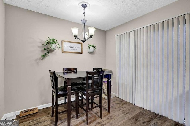 1066 Wedgewood Ln, Tucker, GA 30084 - dining space featuring wood finished floors and a chandelier