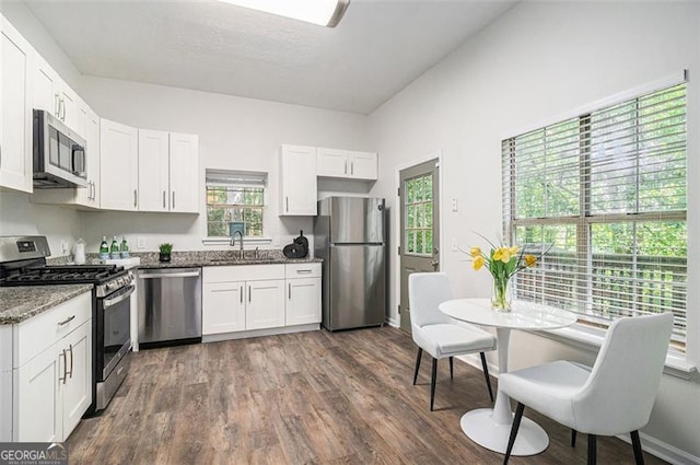 3440 Oaktree, Stonecrest, GA 30038 - kitchen with appliances with stainless steel finishes, white cabinetry, light stone countertops, and dark wood-style floors