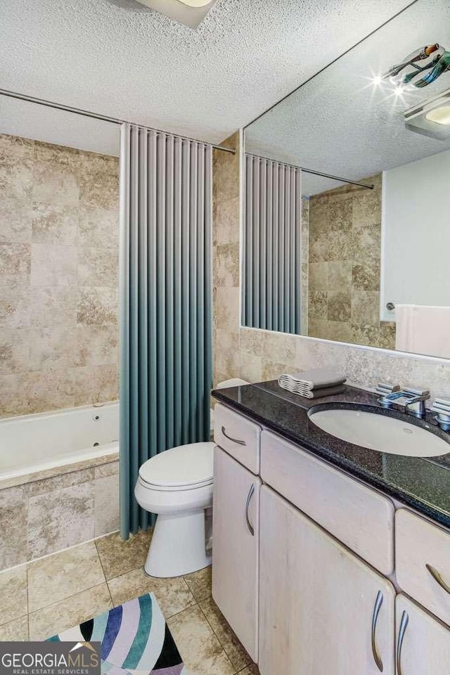 2575 Peachtree Rd NE Unit 15G, Atlanta, GA 30305 - bathroom with vanity, tile walls, a textured ceiling, tile patterned floors, and tiled shower / bath