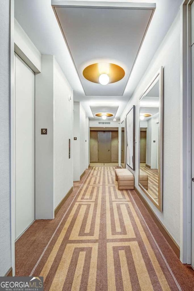 2575 Peachtree Rd NE Unit 15G, Atlanta, GA 30305 - corridor with a tray ceiling and light colored carpet